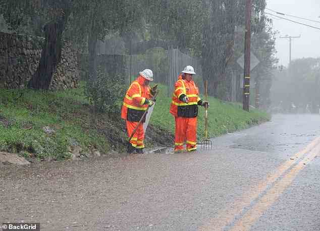 Pictured: Emergency crews on the scene in Montecito Monday assessing the flooded roads