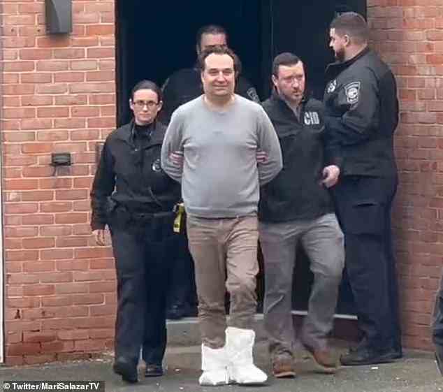 Walshe was seen cracking a smile as he was handcuffed and led out of the station by officers this morning while they continue to search for Ana Walshe, 39