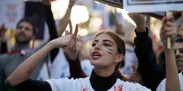 A woman shouts during a protest against the Iranian regime in Berlin, Germany, Oct. 22, 2022, following the death of Mahsa Amini in the custody of the Islamic republic's notorious "morality police."
