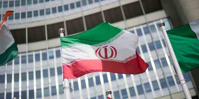 The flag of Iran in front of the International Atomic Energy Agency (IAEA) headquarters ahead of a press conference by Rafael Grossi, director general of the IAEA, about the agency's monitoring of Iran's nuclear energy program May 24, 2021, in Vienna, Austria. 