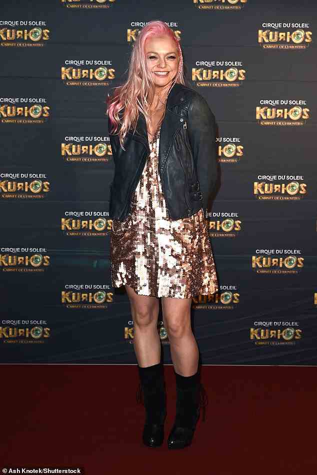 Looking good: The singer, 41, beamed for the camera as she rocked her bubblegum pink hair and teamed her look with black ankle boots