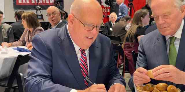 Republican Gov. Larry Hogan of Maryland signs the iconic wooden eggs before addressing "Politics and Eggs," on Oct. 6, 2022. The speaking series at the New Hampshire Institute of Politics is a must stop for potential or actual White House hopefuls.