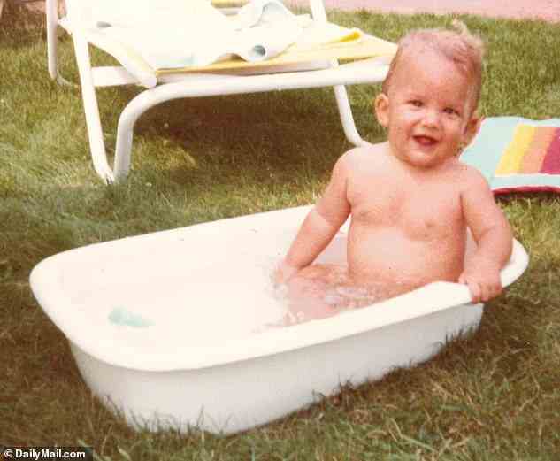 One of the Trump boys is pictured smiling in a small baby bathtub