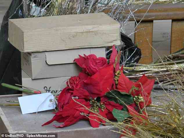 Location: Boxes of red and white roses were seen scattered across the floor