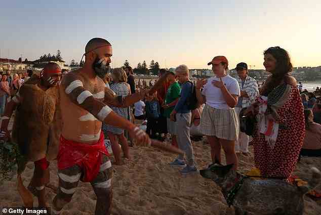 Calls for a weekly 'rent' tax to Aboriginal groups to honour their ancestral claim to the land have been slammed (pictured, First Nations Elder Dean Kelly (left) and Yuin Gurungi dancers lead a Dawn Reflection and Smoking Ceremony at Bondi Beach on Australia Day 2023)