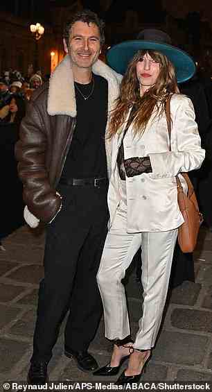 Eye-catching: French singer Lou Doillon looked stylish in a white satin suit and a wide-brimmed hat for the occasion
