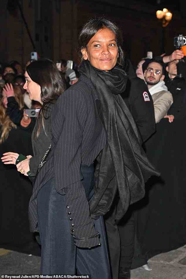 Grinning: Liya Kebede looked sophisticated in navy trousers and a striped blazer for the event