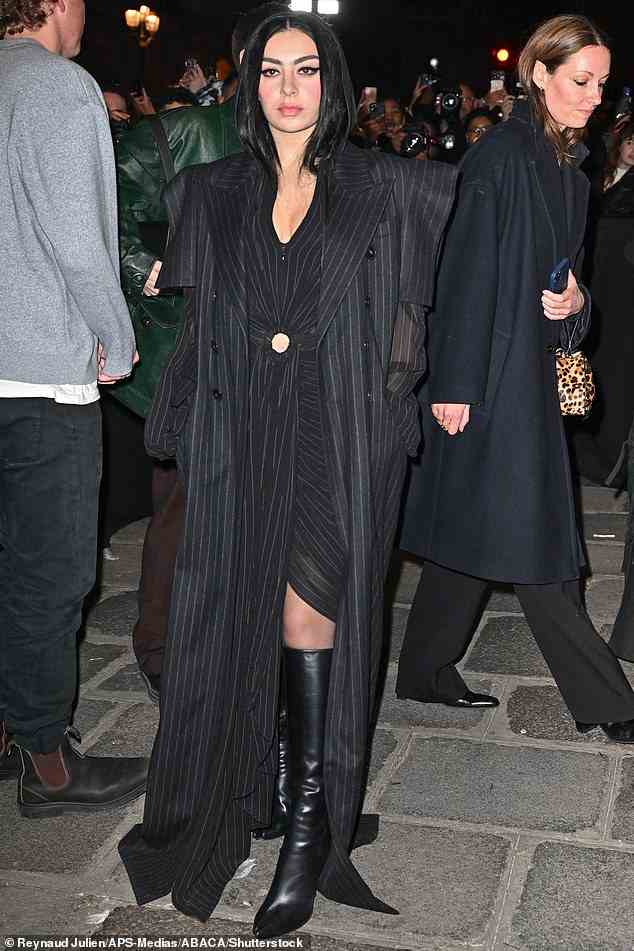 Coordinated: Charlie XCX stunned in a black ruched dress with a bold long pin striped blazer over the top
