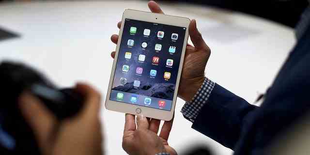 Ein Medienvertreter zeigt am Donnerstag, den 16. Oktober 2014, nach einer Produktankündigung in Cupertino, Kalifornien, USA, ein Apple Inc. iPad Mini 3 für ein Foto. 