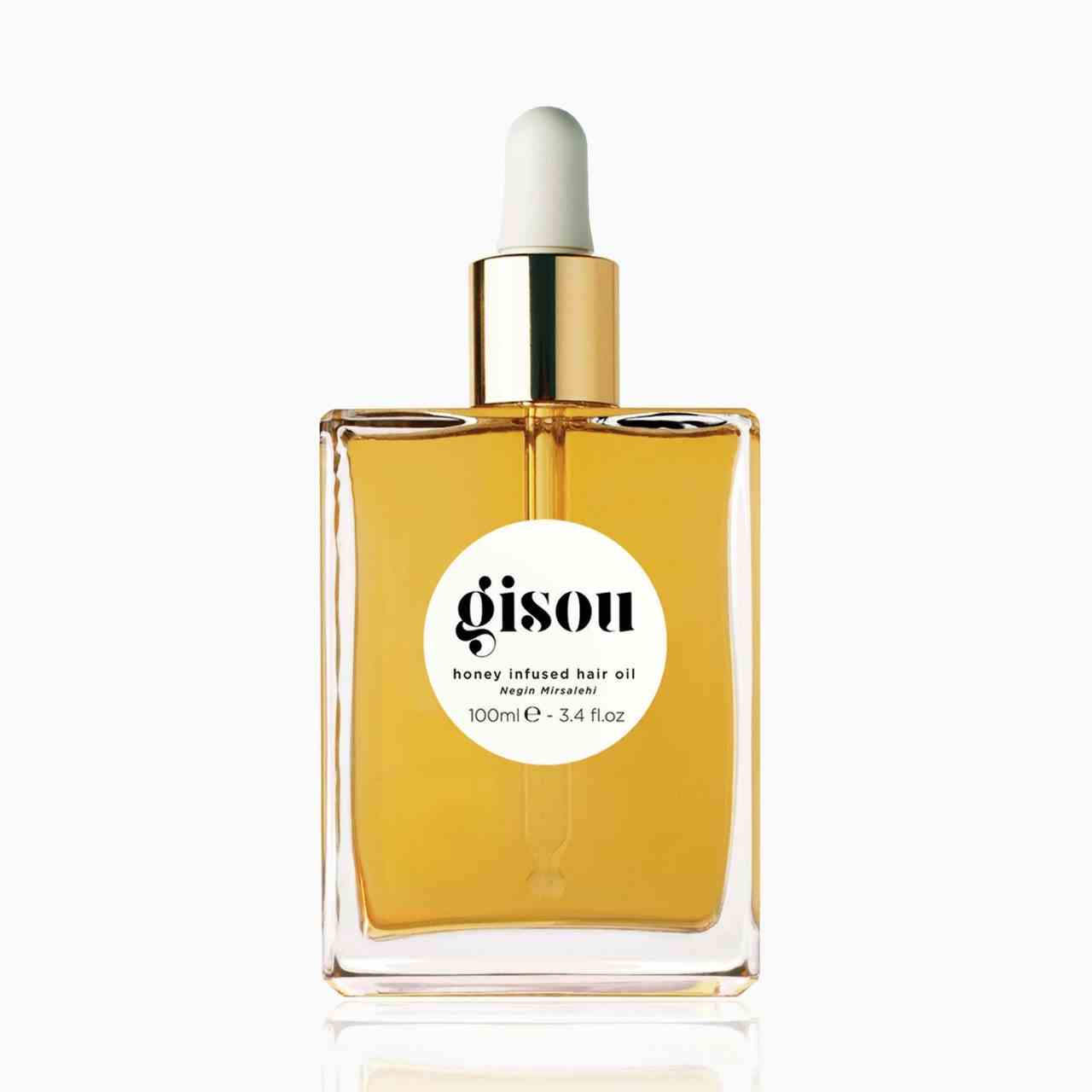 Gisou Honey Infused Hair Oil quadratische Flasche goldenes Haaröl mit goldener und weißer Tropfkappe auf weißem Hintergrund