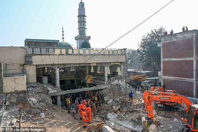 Security personnel and rescue workers search for victims amid the debris of a damaged mosque a day after a blast inside the police headquarters in Peshawar on January 31, 2023