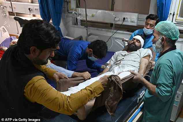 A wounded policeman gets treated at a government hospital a day after the mosque blast inside the police headquarters in Peshawar on January 31, 2023