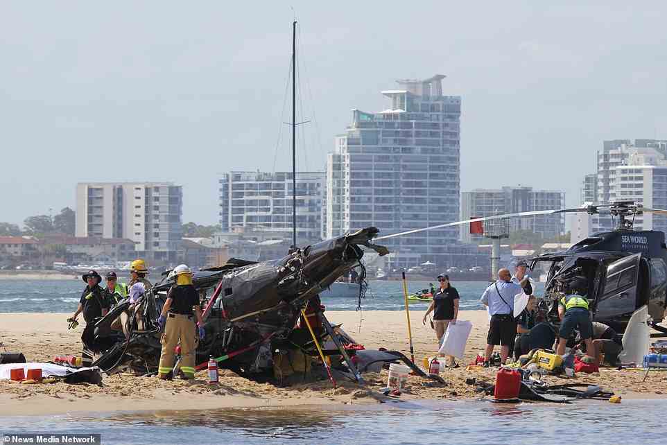 The two helicopters involved in the collision can be seen on the sandbank - with one plummeting into the sand and the other landing upright
