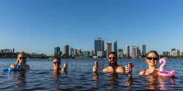 Sarah Jackson, Sam Rowe, Lachlan Alexander und Monica Lewis genießen am 22. Januar 2022 in Perth, Australien, einen Drink und schwimmen im Swan River in South Perth. 