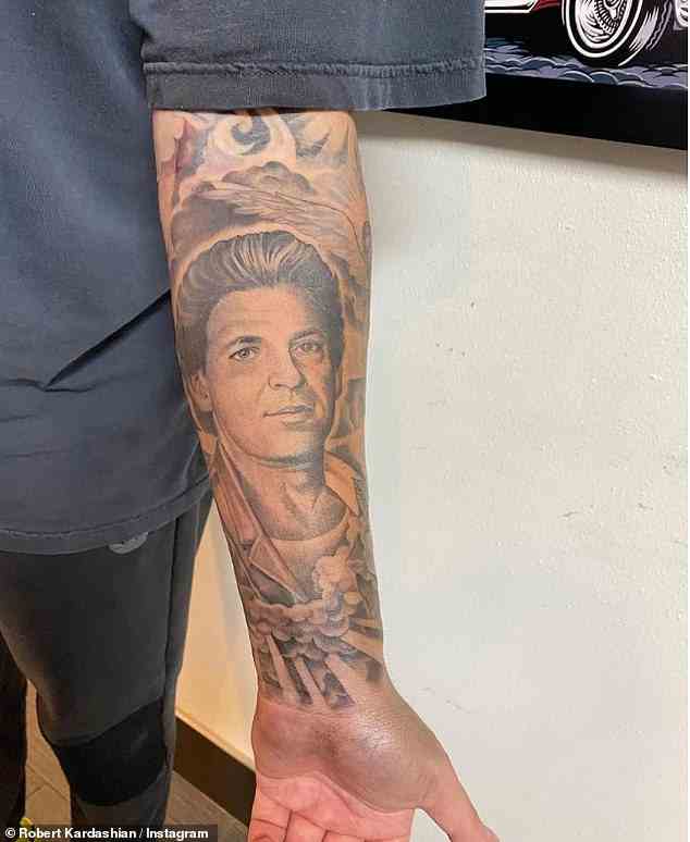 In his memory: One of Rob's tattoos features a life-like drawing of his father, who seems to be emerging from a veil of billowing clouds and light beams
