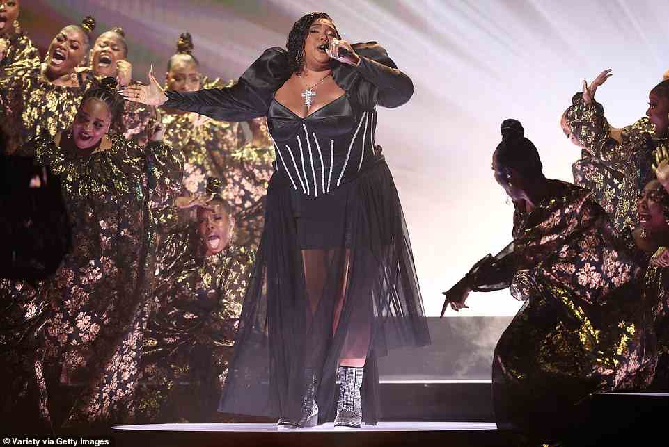Busty: The three-time Grammy-winning singer, 34, hit the stage in a busty black mini dress with sparkling crystals, metallic boots, and a chunky silver cross around her neck