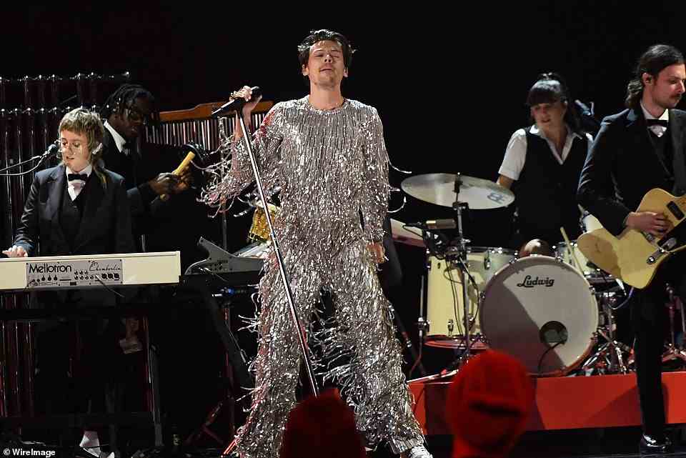Eye-popping: The British singer rocked out the crowd in a metallic fringe jumpsuit as he jumped around the stage on a huge turntable