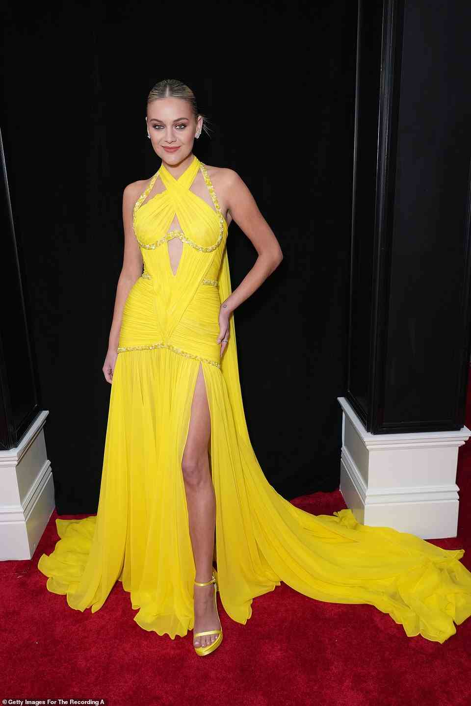 Spring vibes: Kelsea Ballerini rocked a cut-out yellow gown with matching heels