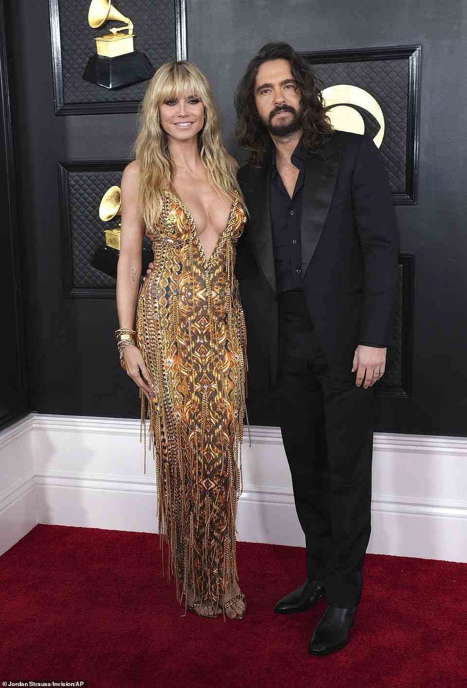 Glow: Heidi Klum rocked a fringed and plunging gown for the Grammys; she arrived with husband Tom Kaulitz