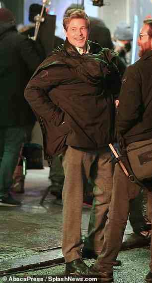 Staying warm: Angelina Jolie's ex-husband braved the chilly weather in an extra jacket which he sported in-between takes
