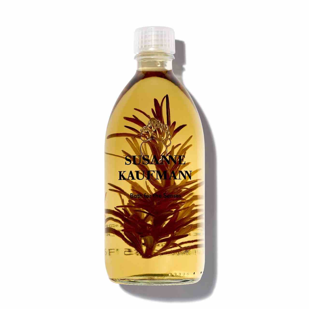 Susanne Kaufmann Ölbad für die Sinne abgerundete Flasche goldenes Badeöl mit Pflanze im Inneren auf weißem Hintergrund