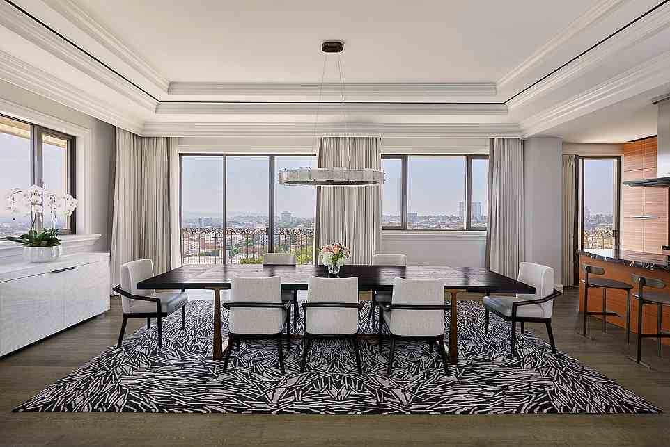 Designers say the suite's open floor plan was made for hosting private parties, with 'guests easily flowing from the media room to the living room to the dining room and onto the terrace'