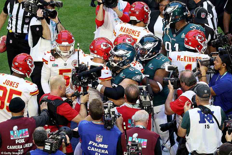 Travis Kelce #87 of the Kansas City Chiefs hugs his brother, Jason Kelce #62 of the Philadelphia Eagles, before Super Bowl LVII
