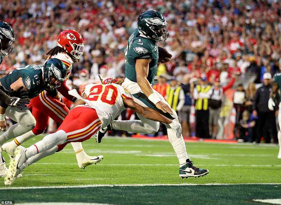 Hurts runs for a touchdown in the second quarter of Super Bowl LVII against Kansas City Chiefs safety Justin Reid (left)