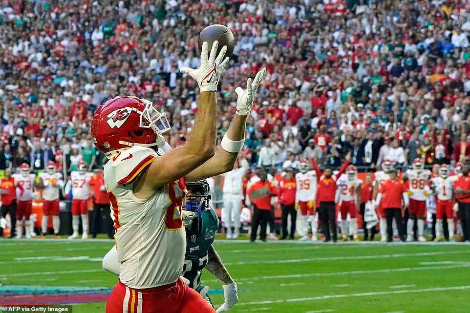 Kelce, who was playing against his brother Jason with their famous mom in crowd at State Farm Stadium, watches ball closely