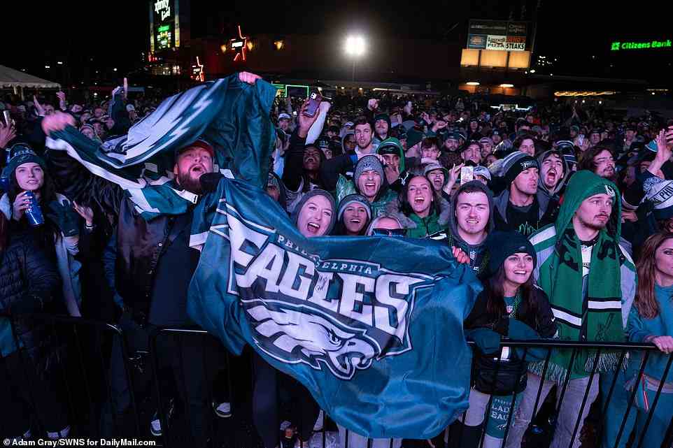 Philadelphia Eagles fans watch Super Bowl LVII at Xfinity Live in Pennsylvania as some wave team flags and banners