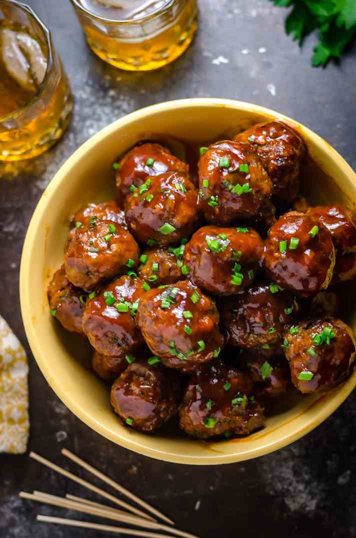 STYLECASTER | 17 Superbowl Snacks You Can Make In a Slow-Cooker | Sticky Bacon-Whiskey Meatballs