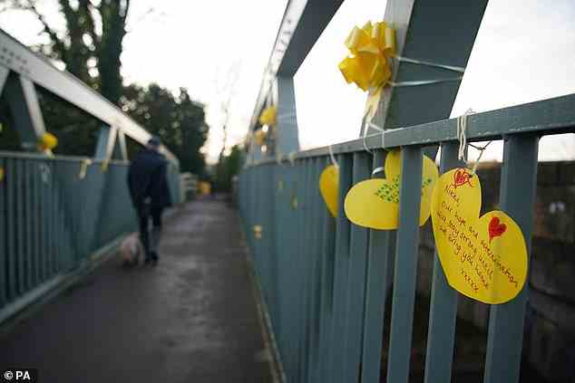 A yellow ribbon with a message of hope written on it tied to a bridge over the River Wyre in St Michael's on Wyre today
