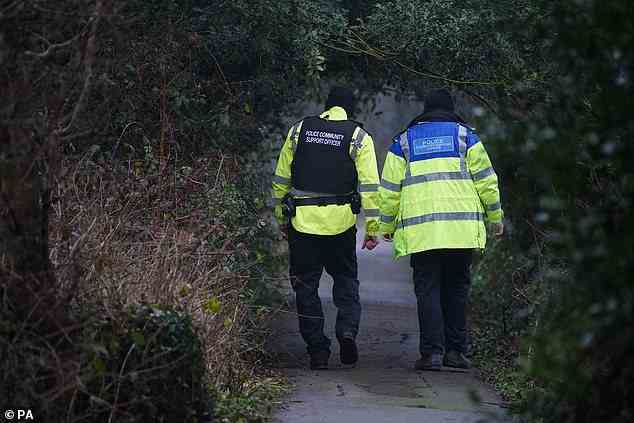 Police officers near the River Wyre in St Michael's on Wyre, Lancashire, as police continue their search today