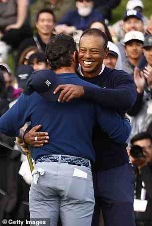 The golf legend hugs Rory McIlroy on the 18th green