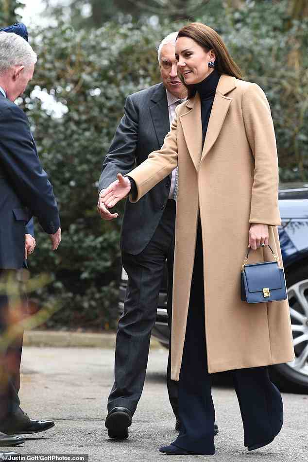 The Princess was elegant in navy as she met with residents of a nursing home in Slough earlier today