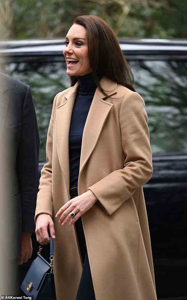 The mother-of-three looked chic for the appearance, opting for a smart navy polo neck with matching trousers and recycled her trendy £470 camel coat from Max&Co