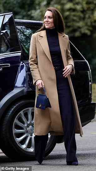 The royal mother-of-three paired her trendy navy ensemble with a camel coat which she has worn on previous occasions