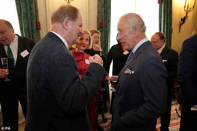 King Charles III was caught on camera smiling and laughing during an animated conversation with author Michael Morpurgo