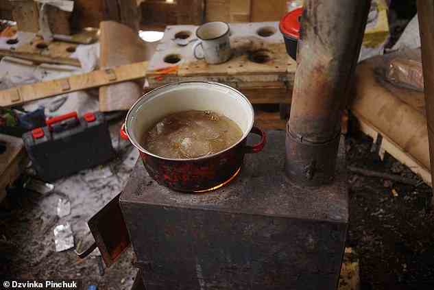 On the stove in the makeshift kitchen, a pan had been filled with snow, which was being melted for water