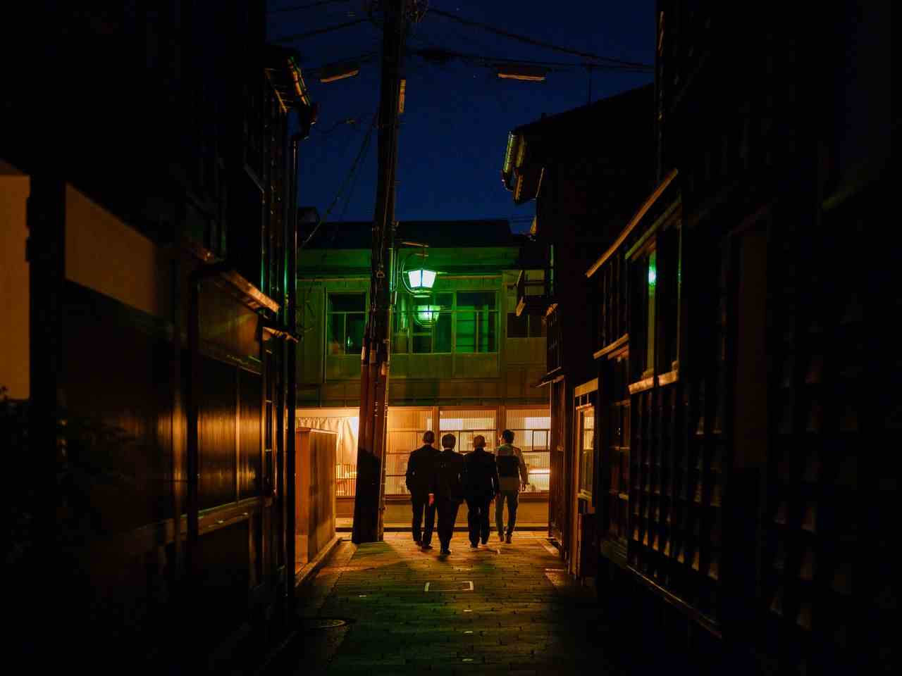 Businessmen walk through the Higashi-chayagai historic teahouse district of Kanazawa.