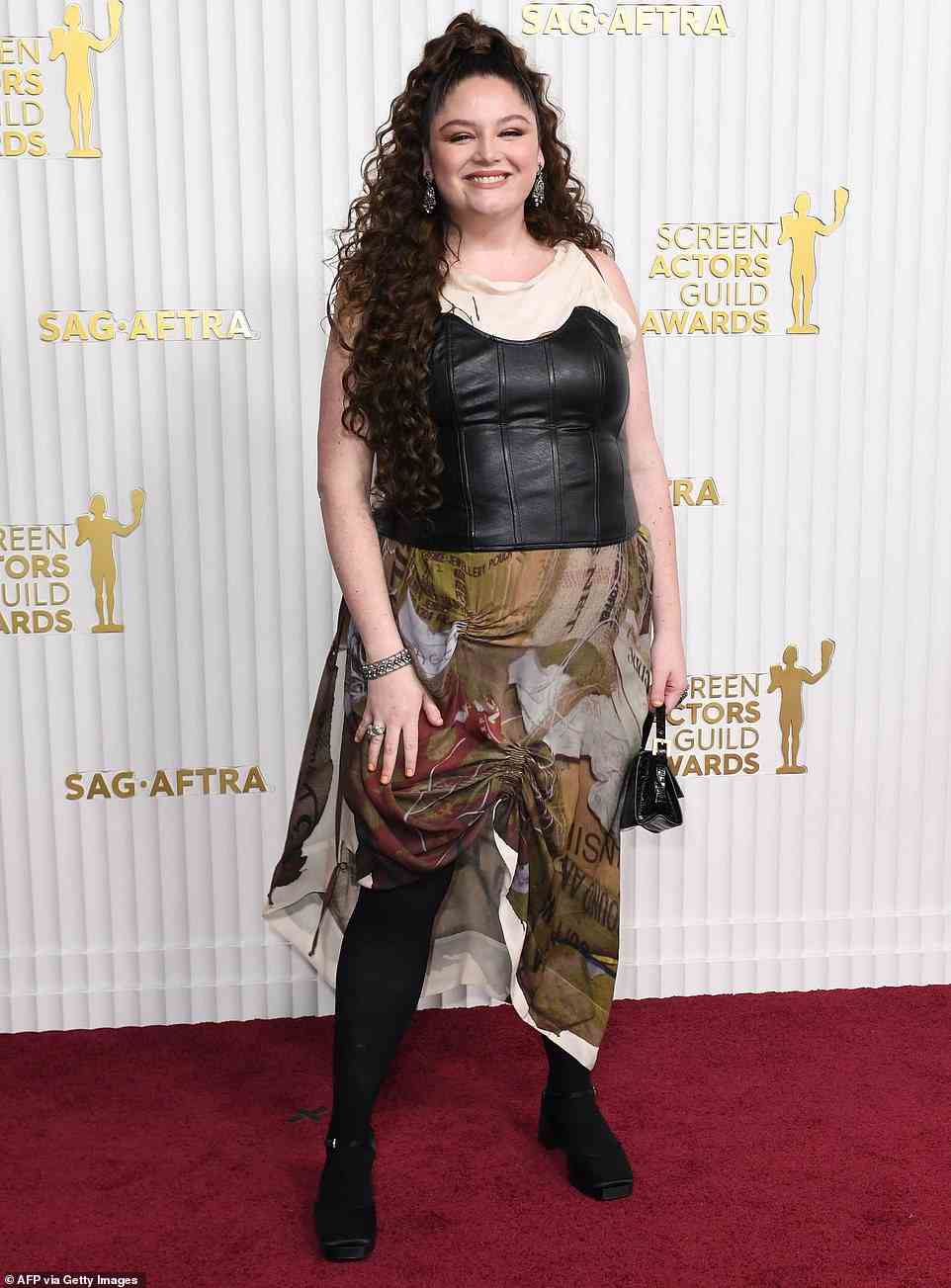 Comedian Megan Stalter flashed back to 90s punk style in a leather corset that was wrapped over a baggy dress - leaving the whole thing looking very mis-matched and disorganized