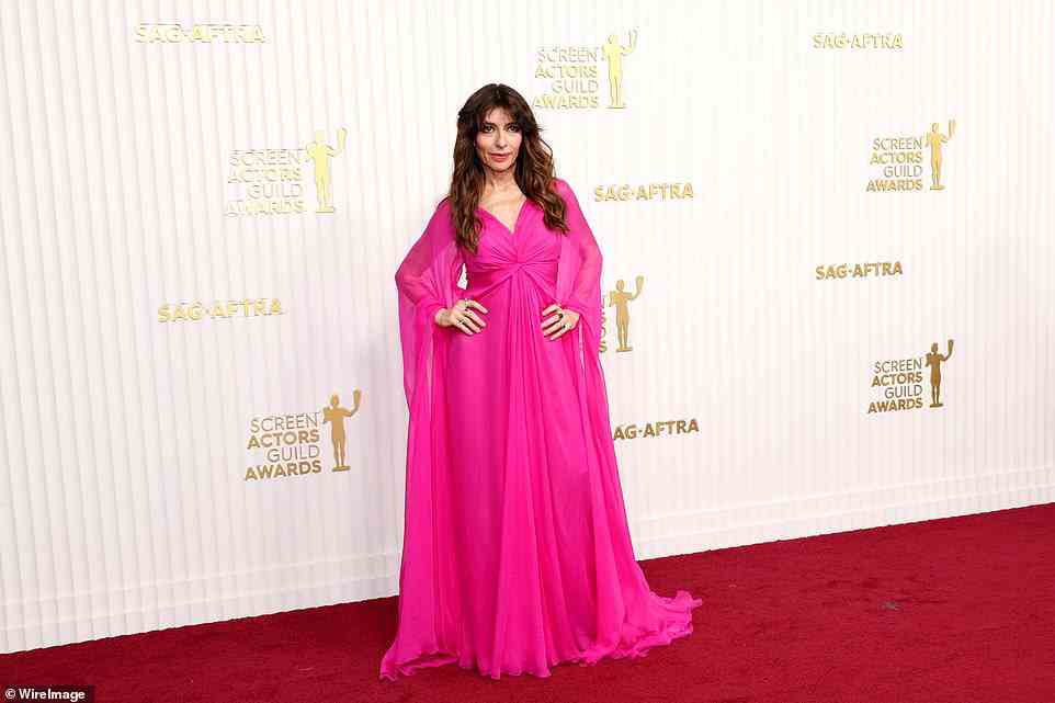 Strike a pose: Sabrina Impacciatore chose a fuchsia hued gown with dramatic caped sleeves. She is wearing Valentino