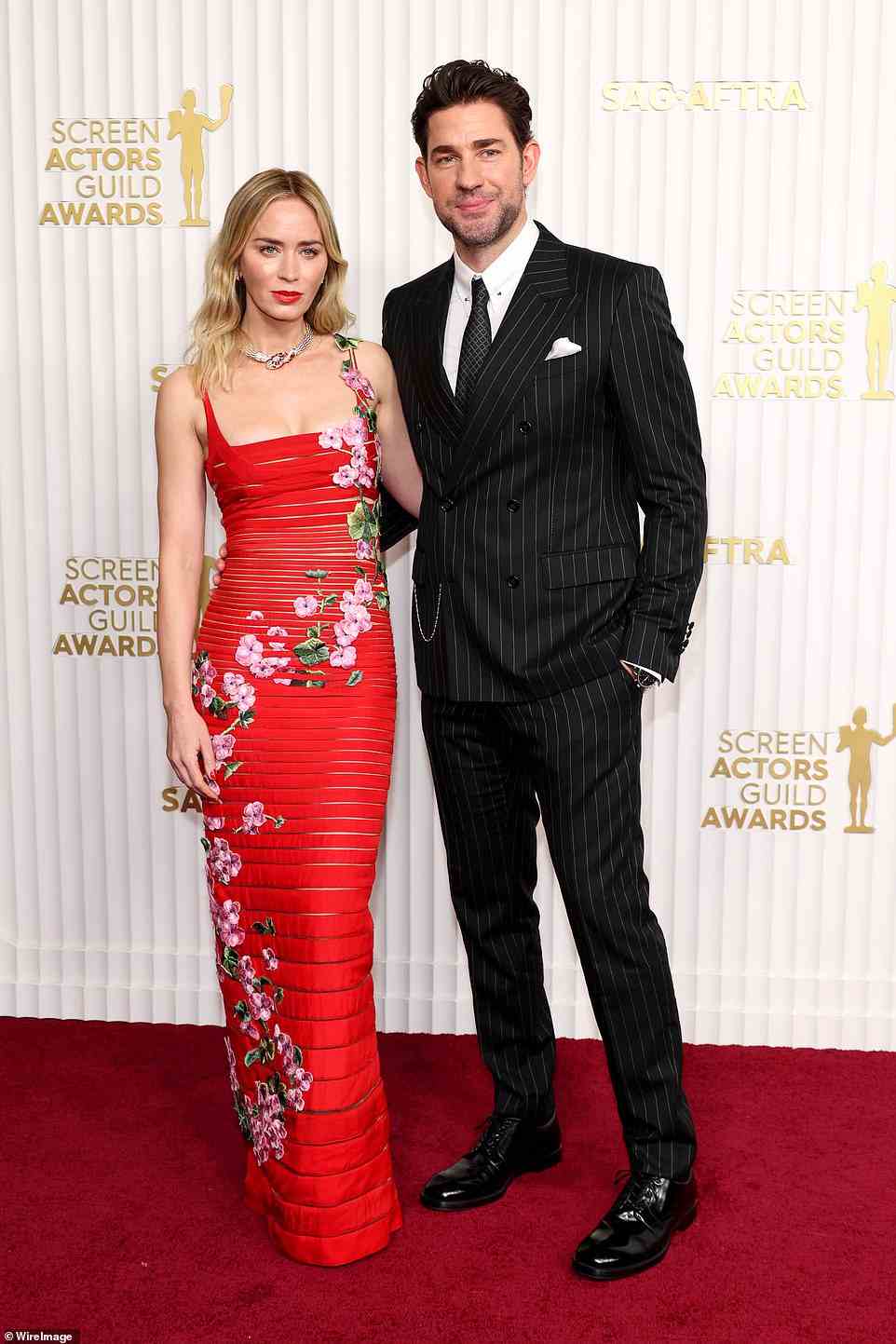 Good looking couple: Emily Blune seen with her husband John Krasinski, who looked dapper in a pinstripe suit