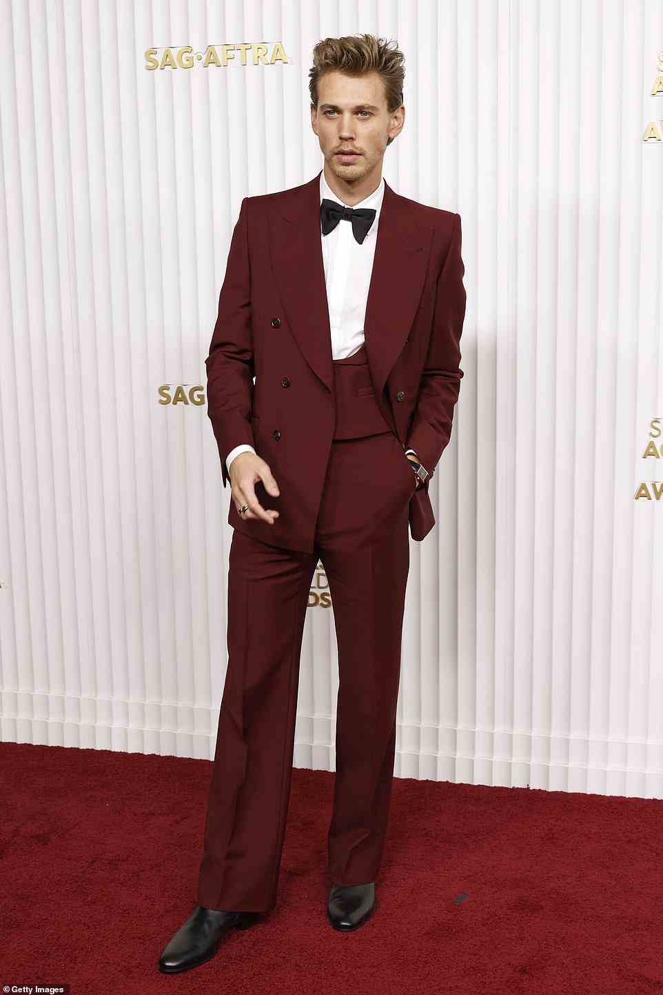 Dapper: Elvis star Austin Butler wore a burgundy suit by Gucci, adding an Omega watch