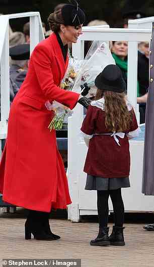 The royal mother-of-three was animated as she accepted a posey of flowers from one young girl at the event