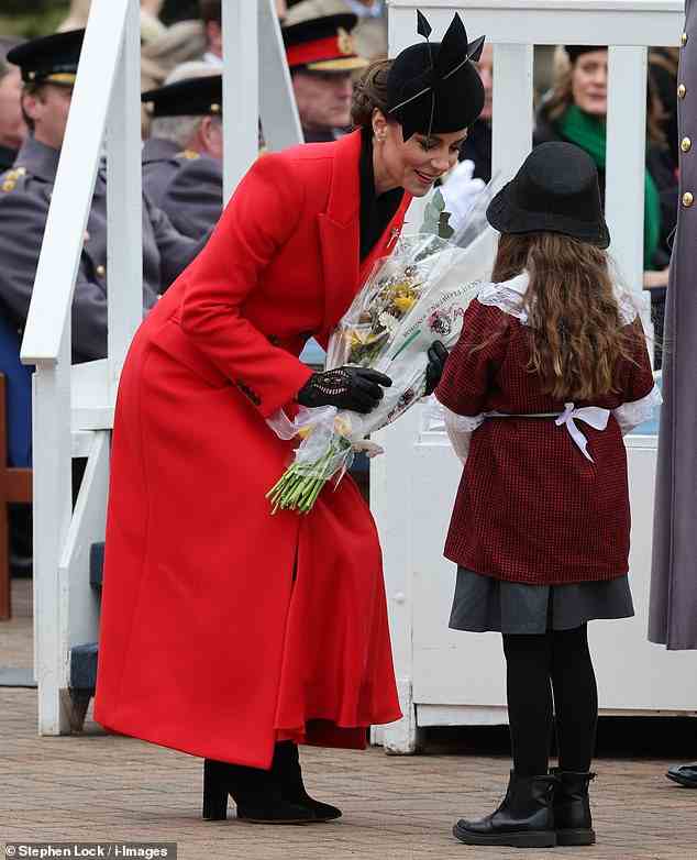 During the parade, Kate showed off her motherly side as she chatted with one young girl attending the event