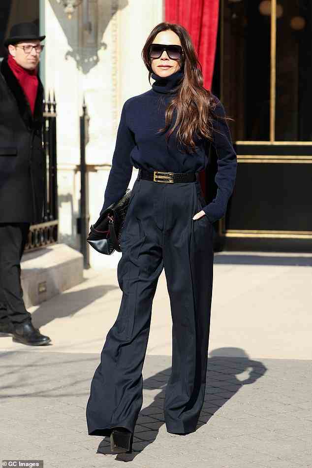 Show ready: Victoria Beckham oozed chic in a tailored navy ensemble as she stepped out in Paris before her fashion week show on Friday