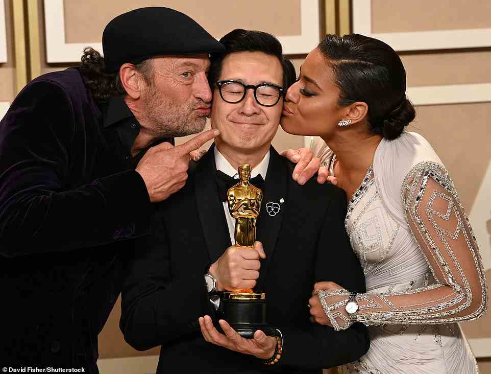Sweet moment: Troy Kotsur and Ariana DeBose gave the talented actor kisses on the cheek as he posed with the Oscar