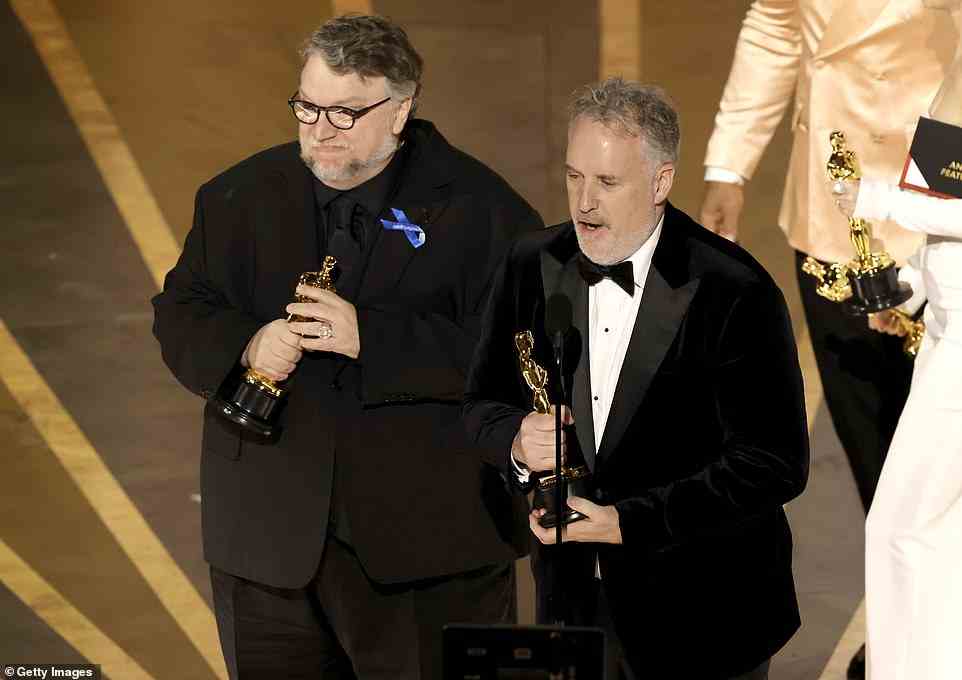Man with the plan:  Guillermo del Toro's Pinocchio triumphed as the film earned the first Oscar of the night in the Best Animated Feature category, del Toro is pictured with director Mark Gustafson