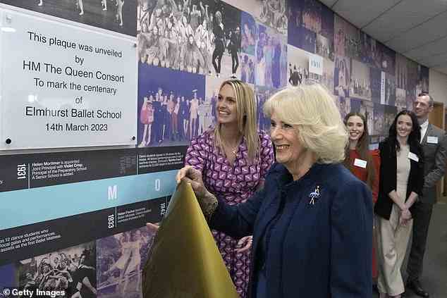 The royal, 75, looked delighted as she peeled off a golden sheet to uncover the decoration - celebrating the school's centenary - during her visit